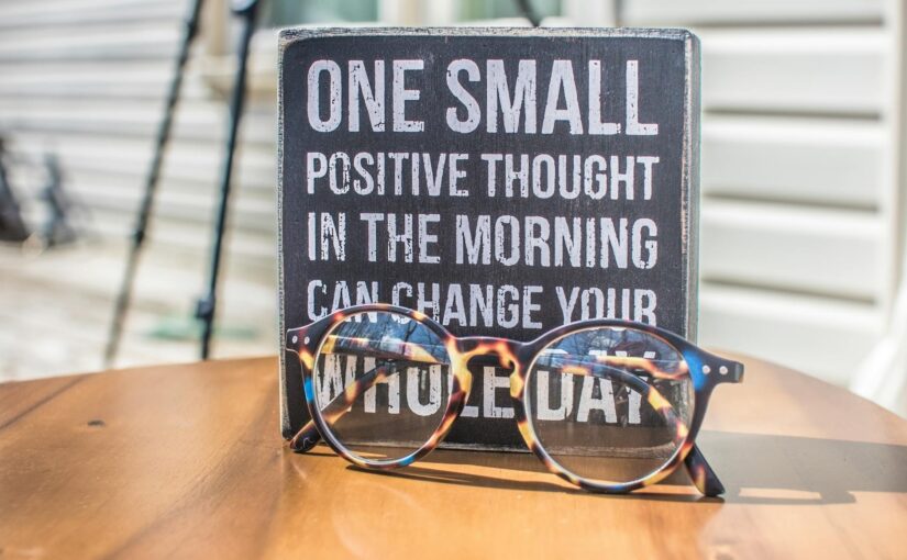 photo of a sign and eyeglasses on table